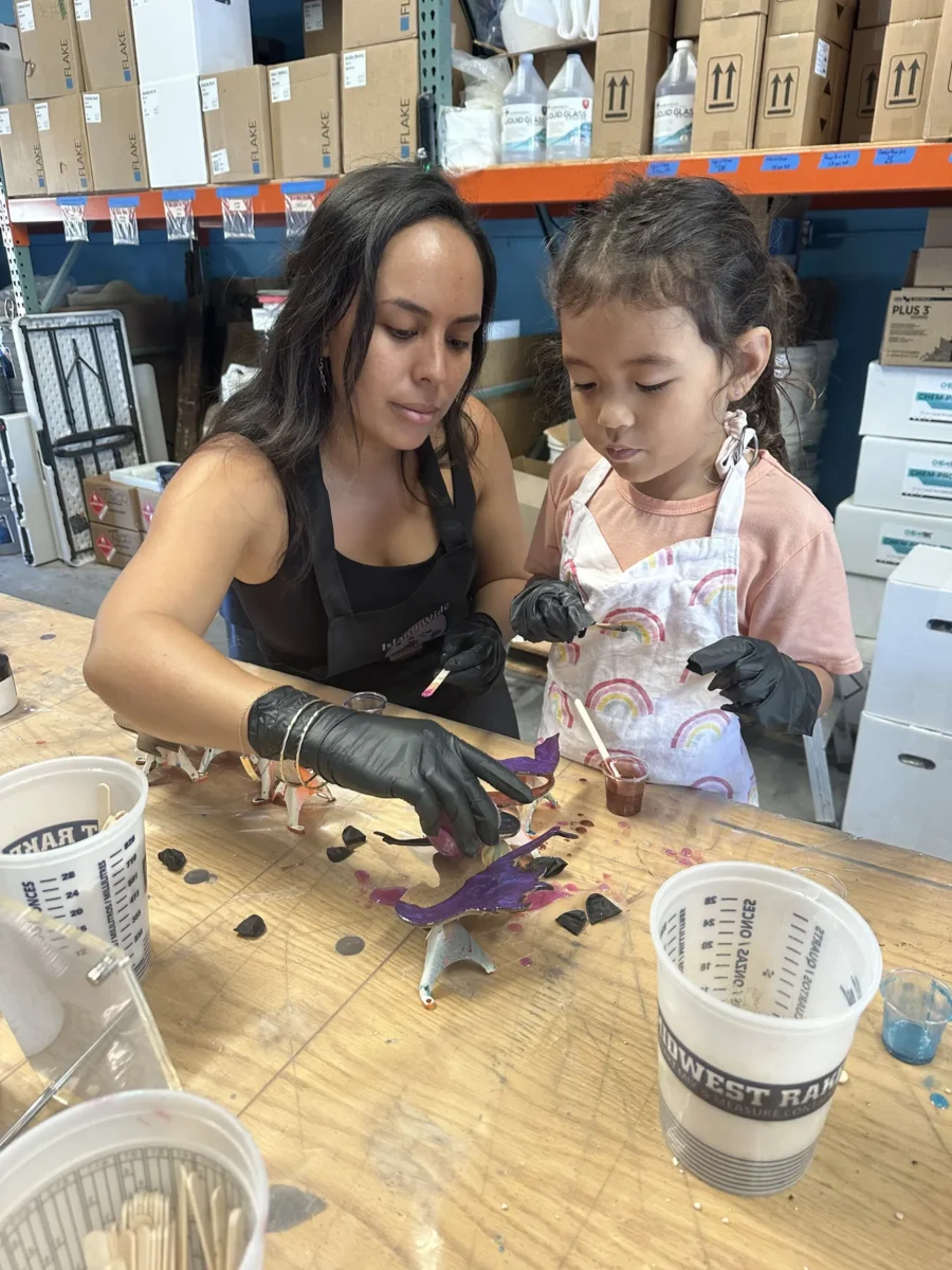 Parent and child working on a resin piece