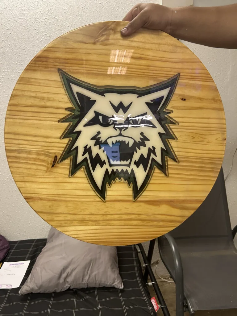Round CNC-carved bobcat logo sign