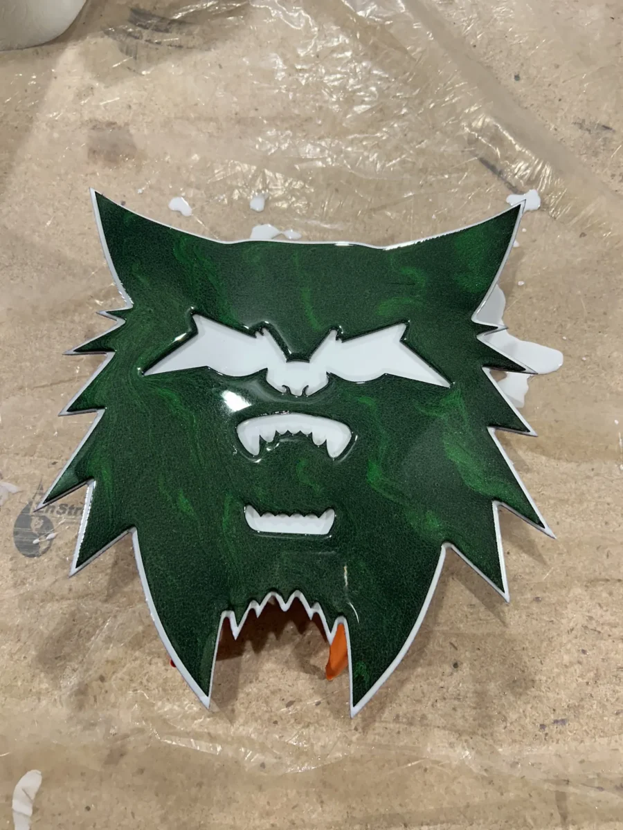 Green CNC-carved bobcat logo