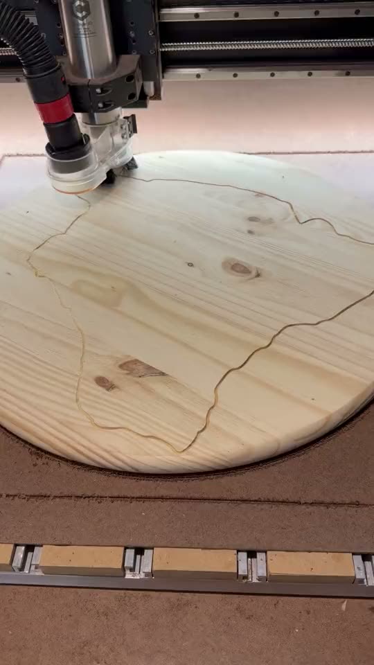 CNC router carving a wood slab