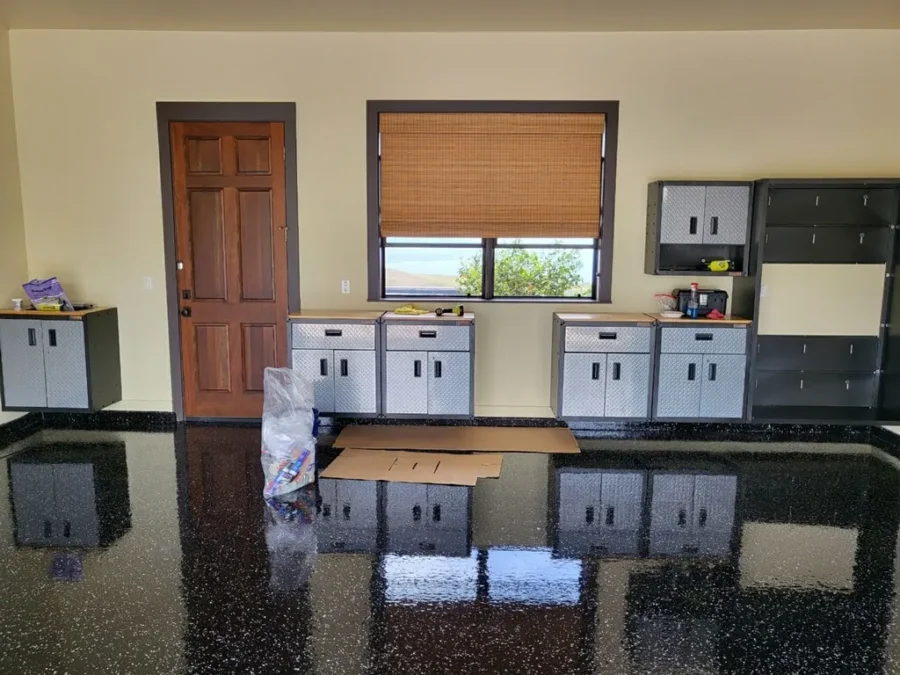 Dark metallic epoxy floor reflecting the room