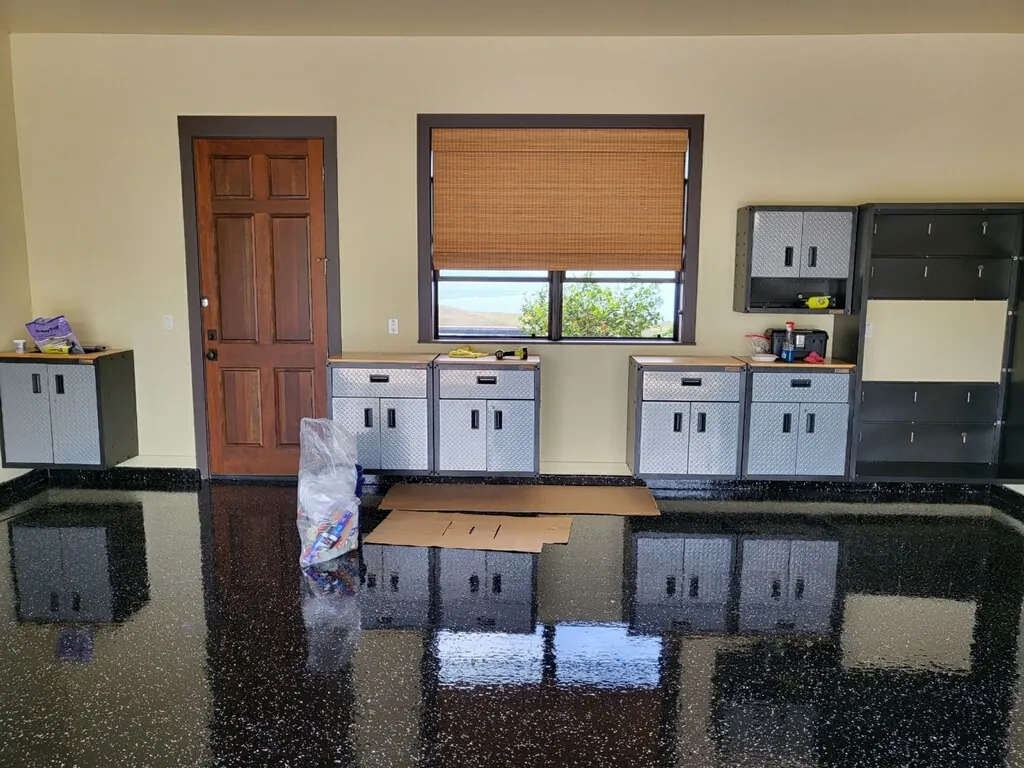 Dark metallic epoxy floor reflecting the room